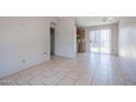 Spacious living room with tiled flooring, a sliding glass door, and access to the kitchen at 3646 N 67Th Ave # 12, Phoenix, AZ 85033