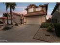 Two-story home with a tile roof, front yard landscaping, and a two-car garage with a long driveway at 4072 E Mountain Vista Dr, Phoenix, AZ 85048