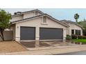 Exterior image featuring a three-car garage and tile roof of a suburban home at 6155 E Karen Dr, Scottsdale, AZ 85254