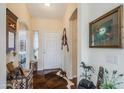 Inviting entryway with hardwood floors, decorative accents, and a view into the adjacent room at 6390 S Granite Dr, Chandler, AZ 85249