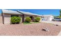 Well-maintained home featuring an arched entryway and xeriscaped front yard at 716 W Nopal Pl, Chandler, AZ 85225