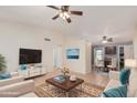 Bright living room with a ceiling fan, tile floors, and modern furnishings at 716 W Nopal Pl, Chandler, AZ 85225