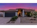 Charming single-story home featuring a well-maintained lawn, two car garage and inviting entrance at 756 E Appaloosa Rd, Gilbert, AZ 85296