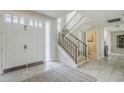 Bright entryway with staircase and view of a doorway, tiled flooring and a light-colored rug at 8100 E Camelback Rd # 143, Scottsdale, AZ 85251