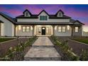 Beautiful exterior elevation with custom stonework and covered porch, creating an inviting facade at 8147 E Redberry --, Mesa, AZ 85207