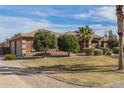 Well-maintained home with mature trees, verdant lawn, and neatly trimmed shrubs enhancing the curb appeal at 838 W Via De Palmas --, San Tan Valley, AZ 85140