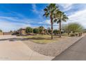 Lovely home with lush trees, a verdant lawn, and neat desert landscaping enhancing the curb appeal at 838 W Via De Palmas --, San Tan Valley, AZ 85140