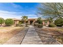 Charming home featuring a landscaped front yard, desert landscaping and a inviting walkway to the front entrance at 838 W Via De Palmas --, San Tan Valley, AZ 85140