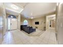 Cozy living room with ample natural light, ceiling fan, and tile flooring transitioning to soft carpeting at 866 N Forest --, Mesa, AZ 85203