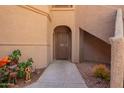 Welcoming entrance to the unit, decorated with desert plants and a secure screen door at 9735 N 94Th Pl # 110, Scottsdale, AZ 85258