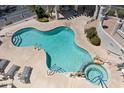 Aerial view of a community pool, hot tub and lounge chairs with desert landscaping and stair access to other amenities at 9750 N Monterey Dr # 50, Fountain Hills, AZ 85268