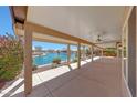 Spacious covered patio overlooking a serene waterfront view, perfect for outdoor relaxation and entertainment at 10913 W Chino Dr, Peoria, AZ 85373