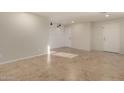 Spacious living room with tile floors, shiplap accent wall, and recessed lighting at 12056 W Melinda Ln, Sun City, AZ 85373