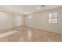 Open-concept living room features tile floors, recessed lighting, and a front door at 12056 W Melinda Ln, Sun City, AZ 85373