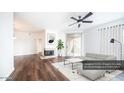 Bright living room featuring a fireplace, hardwood floors, and modern furnishings at 1411 E Orangewood Ave # 123, Phoenix, AZ 85020