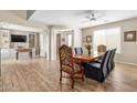 Inviting dining room featuring decorative chairs, wood floors, and adjacent living space at 15658 W Cortez St, Surprise, AZ 85379