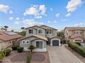 Aerial view of a two-story home with desert landscaping and a three-car garage at 16533 W Carmen Dr, Surprise, AZ 85388