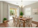 Charming dining room with a sliding glass door to the backyard at 16771 W Adams St, Goodyear, AZ 85338