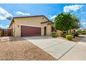 Well-manicured front yard and exterior view of a lovely single-Gathering home with a brown garage door at 16771 W Adams St, Goodyear, AZ 85338