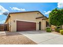 Charming home exterior with a spacious driveway and low-maintenance desert landscaping at 16771 W Adams St, Goodyear, AZ 85338