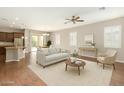 Bright and airy living room features a modern open floor plan and wood floors at 16771 W Adams St, Goodyear, AZ 85338