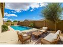 Inviting pool area with comfortable seating and a well-maintained yard at 16771 W Adams St, Goodyear, AZ 85338
