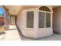 Covered front entrance features decorative windows and a secure screen door at 18850 N 16Th Pl, Phoenix, AZ 85024