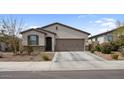 Well-maintained home with a two-car garage, desert landscaping, and a cozy front porch at 1924 S 82Nd Cir, Mesa, AZ 85209