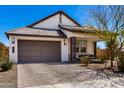 Charming single-story home featuring a two-car garage and manicured landscaping at 19305 S 209Th Pl, Queen Creek, AZ 85142