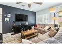 Comfortable living room with a modern entertainment center, a cozy sofa, and plenty of natural light at 2169 N 212Th Ln, Buckeye, AZ 85396