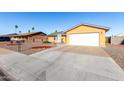Charming single-story home with a two-car garage and low maintenance desert landscaping at 2581 E Commonwealth Cir, Chandler, AZ 85225