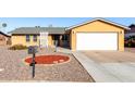 Charming single-story home featuring a two-car garage and low maintenance desert landscaping at 2581 E Commonwealth Cir, Chandler, AZ 85225