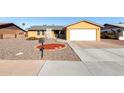 Charming single-story home featuring a two-car garage and low maintenance desert landscaping at 2581 E Commonwealth Cir, Chandler, AZ 85225