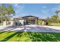 A modern home's exterior boasts a contemporary design, with a large driveway and well-manicured lawn at 345 W Gardenia Dr, Phoenix, AZ 85021