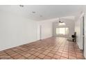 Open-concept living room with a large window, vaulted ceiling and tile floors at 448 E Wescott Dr, Phoenix, AZ 85024