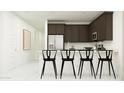 Stylish kitchen featuring dark cabinetry and an island with seating for four at 4646 E French Rd, San Tan Valley, AZ 85143