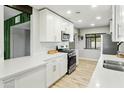 Modern kitchen boasts stainless steel appliances, white cabinets, and stylish tile flooring at 4938 W Tuckey Ln, Glendale, AZ 85301