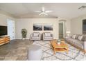 Bright living room featuring neutral paint, ceiling fan, and stylish furniture at 5133 S Brice --, Mesa, AZ 85212