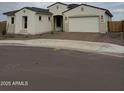 Charming single-story home featuring a two-car garage, neutral stucco, and a tile roof at 5147 N 177Th Ln, Litchfield Park, AZ 85340