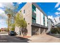 Modern apartment complex with a black car and a gated parking garage at 525 E Willetta St # 2, Phoenix, AZ 85004