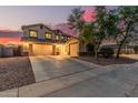 Inviting two-story home showcasing a three-car garage and a neatly landscaped front yard at 6804 S 45Th Gln, Laveen, AZ 85339