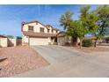 Inviting two-story home with a spacious driveway and mature landscaping at 6804 S 45Th Gln, Laveen, AZ 85339