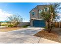 Two-story home with a blue garage door and desert landscaping at 6823 W Getty Dr, Phoenix, AZ 85043