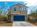 Two-story home with a blue garage door, desert landscaping, and neutral paint scheme at 6823 W Getty Dr, Phoenix, AZ 85043