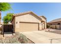 Charming single-story home featuring a two-car garage and low maintenance desert landscaping at 6970 W Paso Trl, Peoria, AZ 85383