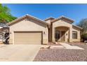 Charming single-story home featuring a two-car garage and low maintenance desert landscaping at 6970 W Paso Trl, Peoria, AZ 85383