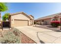 Charming single-story home featuring a two-car garage and low maintenance desert landscaping at 6970 W Paso Trl, Peoria, AZ 85383