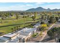 Stunning aerial view of the community, golf course, and mountain views creates a tranquil setting at 7939 E Via Linda --, Scottsdale, AZ 85258