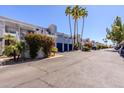 Image of condominiums with blue doors, bougainvillea and palm trees at 902 W Glendale Ave # 115, Phoenix, AZ 85021