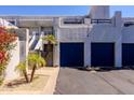 Condominiums with blue doors, palm trees, and desert landscaping at 902 W Glendale Ave # 115, Phoenix, AZ 85021